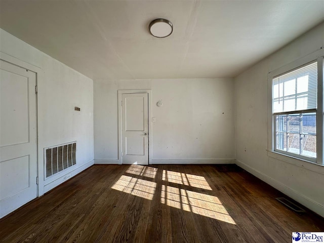 unfurnished room with dark hardwood / wood-style floors