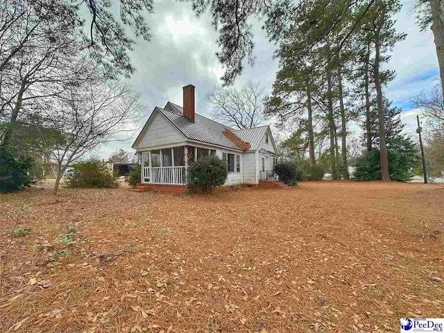 view of home's exterior featuring a sunroom