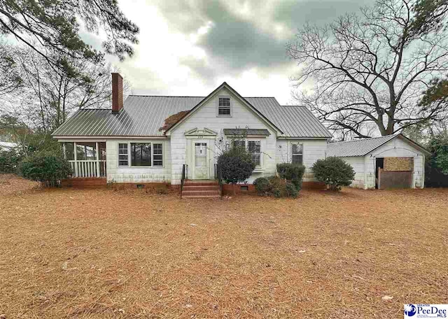 view of front of house featuring a garage and an outdoor structure