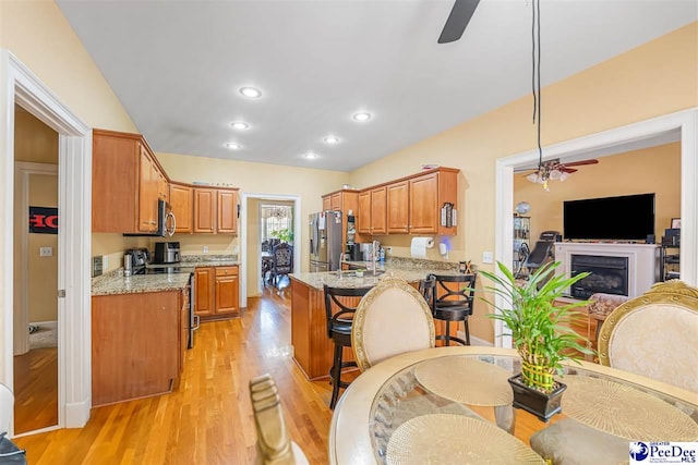 953 Rice Planters Ln, Florence, SC 29501 - dining area featuring a ceiling fan, light wood-style flooring, a glass covered fireplace, and recessed lighting