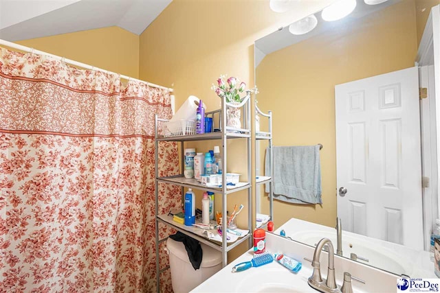full bath featuring vaulted ceiling, vanity, and a shower with curtain