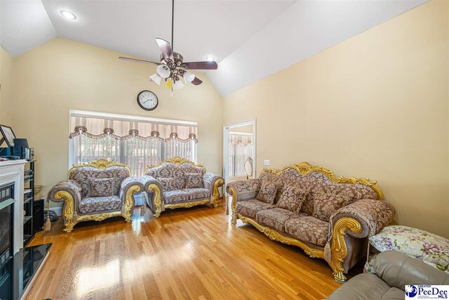 953 Rice Planters Ln, Florence, SC 29501 - living room featuring ceiling fan, high vaulted ceiling, wood finished floors, and a glass covered fireplace