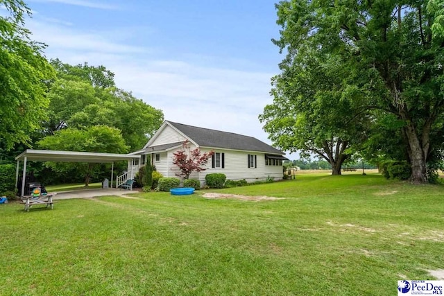 213 Newman Swamp Rd, Lamar, SC 29069 - view of side of home with a lawn and a detached carport