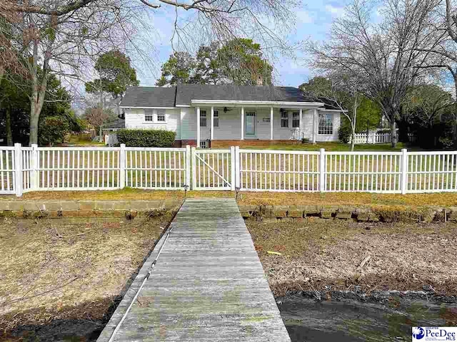 back of house featuring a fenced front yard and a gate