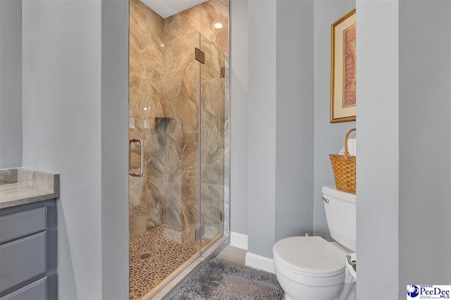 bathroom with vanity, an enclosed shower, and toilet