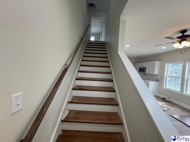 stairs with baseboards, visible vents, recessed lighting, wood finished floors, and ceiling fan