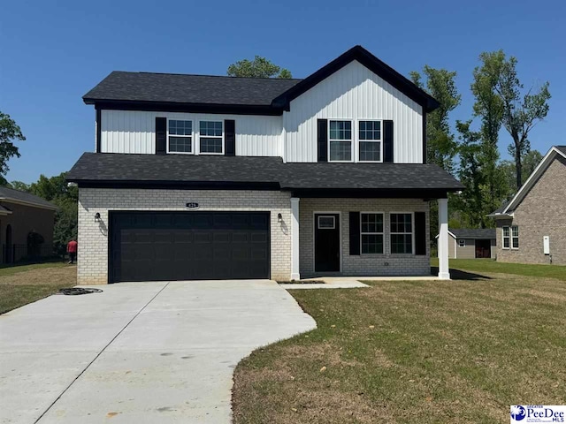modern farmhouse featuring an attached garage, driveway, brick siding, and a front yard