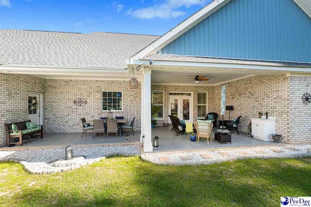 view of patio with an outdoor living space, ceiling fan, and french doors