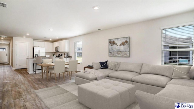 560 Strawberry Field Way, Galivants Ferry, SC 29544 - living room featuring light wood finished floors and recessed lighting