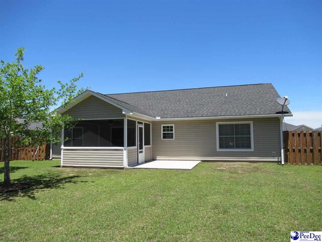 3004 Colton Dr, Florence, SC 29501 - rear view of house featuring a sunroom, a patio area, and a shingled roof