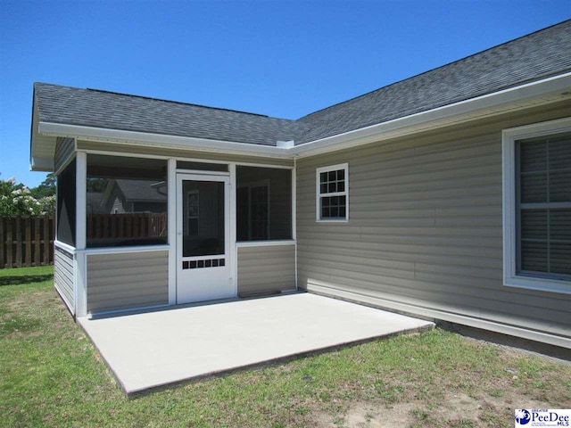 3004 Colton Dr, Florence, SC 29501 - rear view of property with a shingled roof, a patio area, and a sunroom