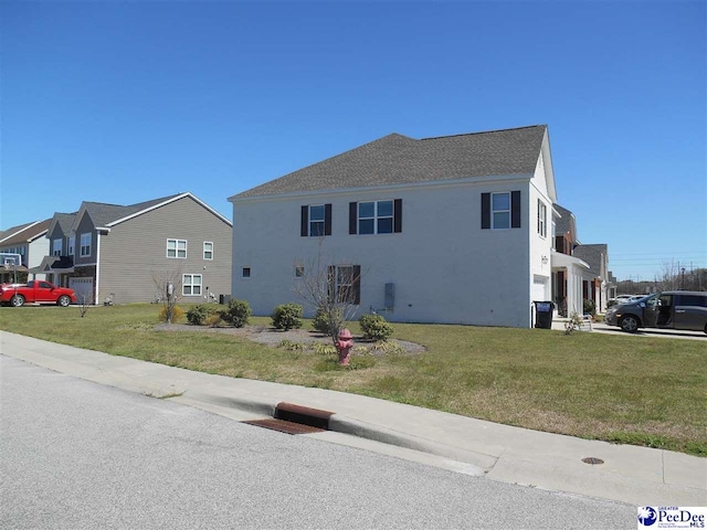 1081 Wessex Dr, Florence, SC 29501 - view of front of home featuring a front lawn, a residential view, and stucco siding