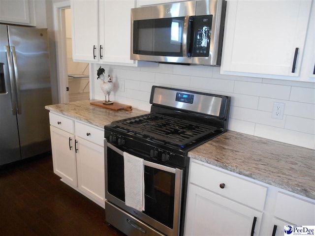 1081 Wessex Dr, Florence, SC 29501 - kitchen featuring backsplash, dark wood-type flooring, light stone counters, appliances with stainless steel finishes, and white cabinetry