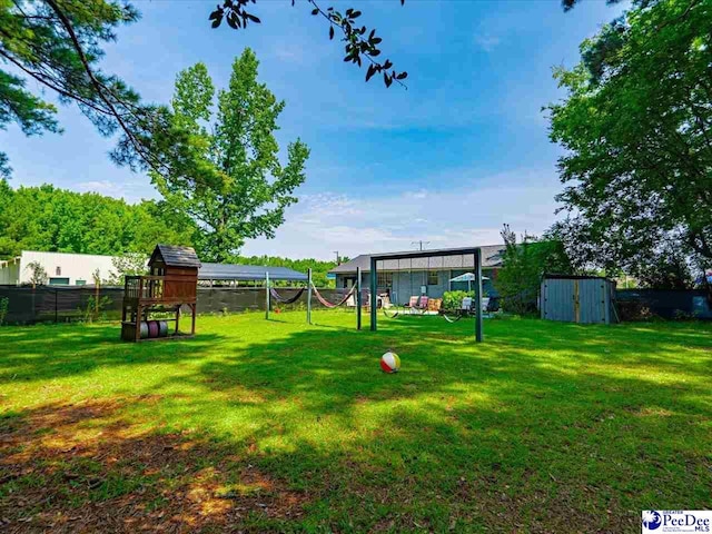 view of yard featuring a playground and a storage unit