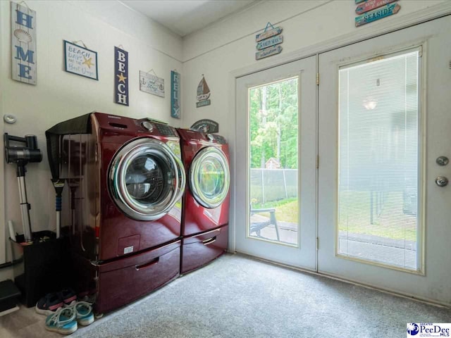 washroom with washing machine and dryer and carpet