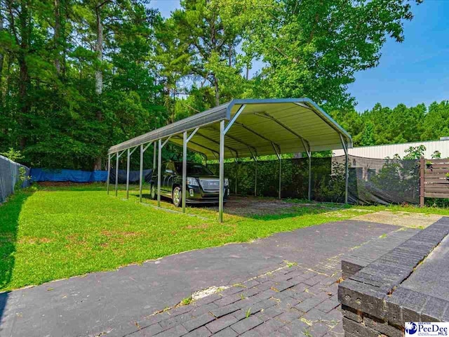 view of parking with a yard and a carport