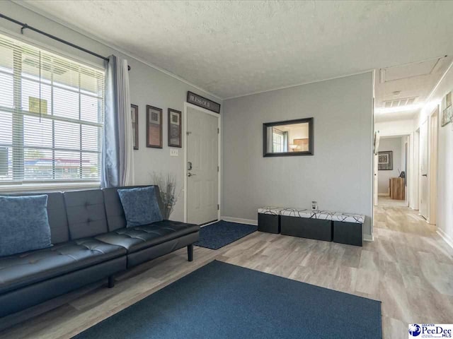 unfurnished living room featuring light hardwood / wood-style flooring and a textured ceiling