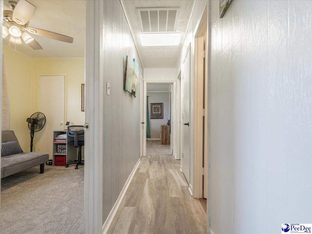 hallway featuring light colored carpet