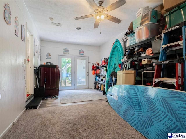 interior space with ceiling fan and carpet