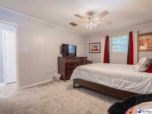 carpeted bedroom featuring ceiling fan, crown molding, and a textured ceiling