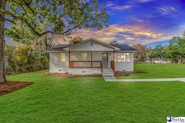 view of front of home with a yard and a porch