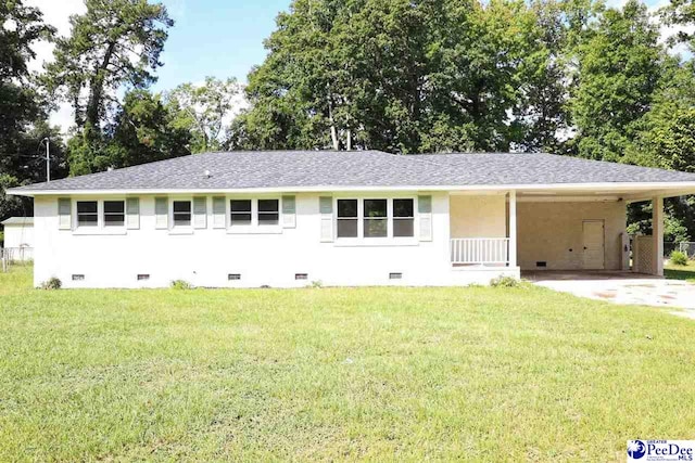 ranch-style house featuring a front lawn and a carport