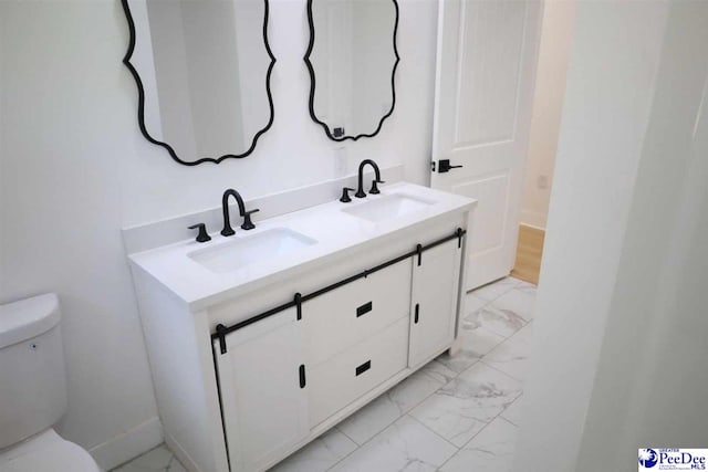 bathroom with vanity and toilet