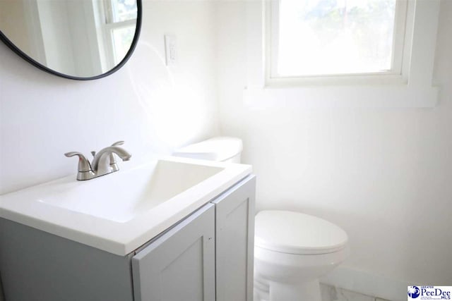 bathroom featuring vanity and toilet