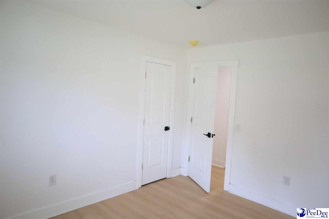 empty room with light hardwood / wood-style floors