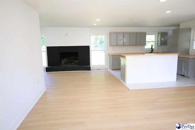 kitchen with gray cabinets, sink, and light hardwood / wood-style floors