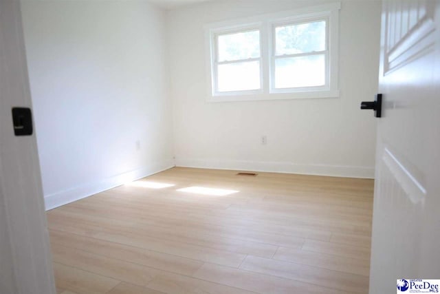 spare room featuring light hardwood / wood-style flooring