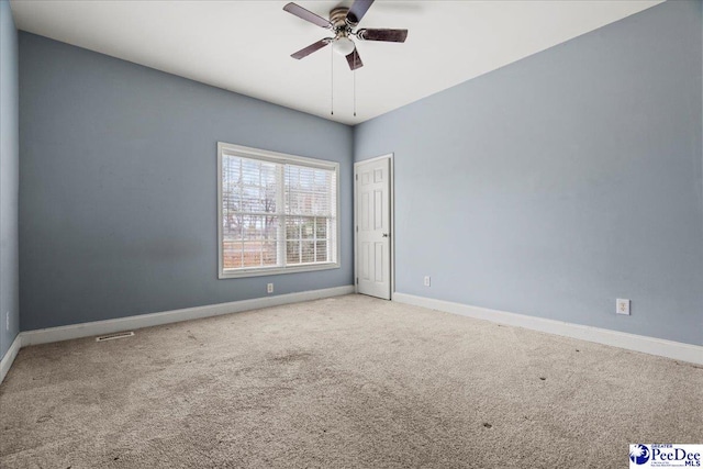 carpeted spare room with ceiling fan