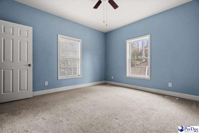 unfurnished room with carpet and ceiling fan