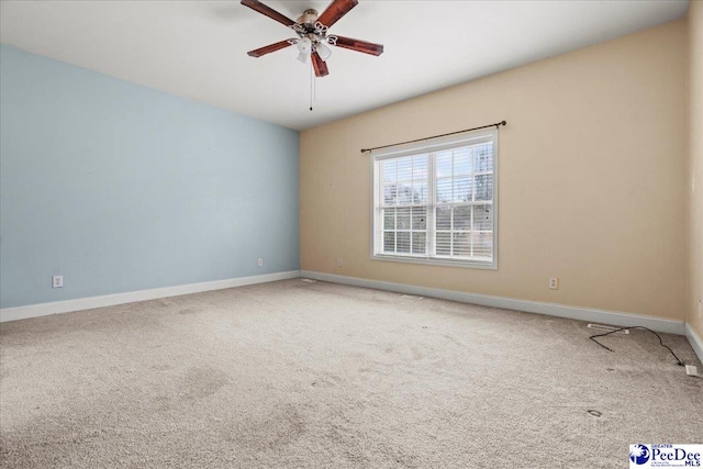 spare room with carpet flooring and ceiling fan