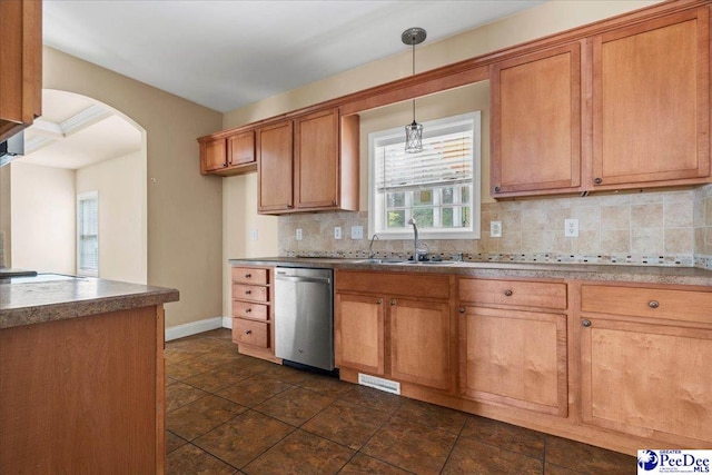 kitchen featuring hanging light fixtures, tasteful backsplash, sink, and stainless steel dishwasher