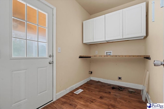 clothes washing area with cabinets, hookup for an electric dryer, dark hardwood / wood-style flooring, and hookup for a washing machine