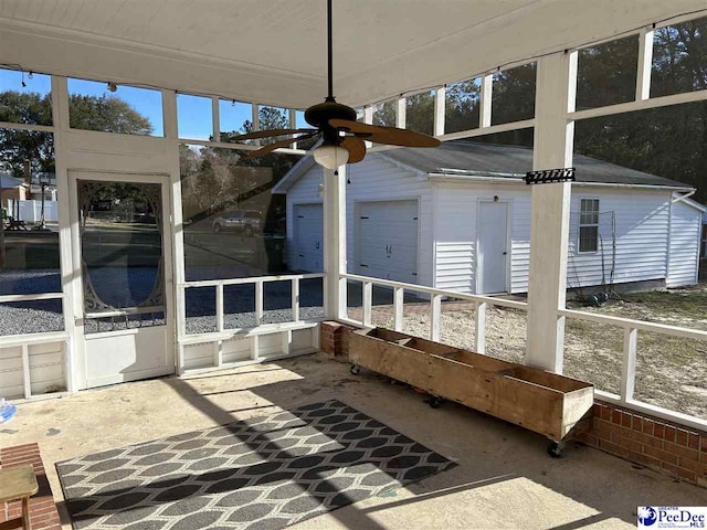 unfurnished sunroom featuring a ceiling fan