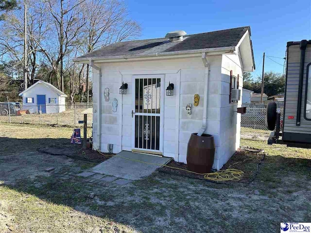 view of outbuilding with fence