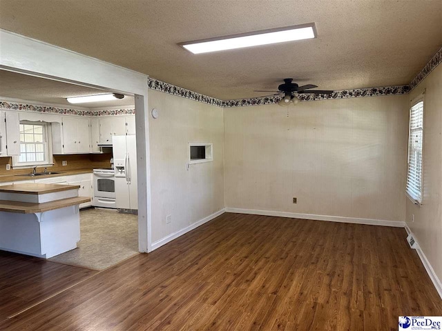1824 Furman Dr, Florence, SC 29501 - empty room featuring a sink, dark wood-style flooring, a textured ceiling, baseboards, and ceiling fan