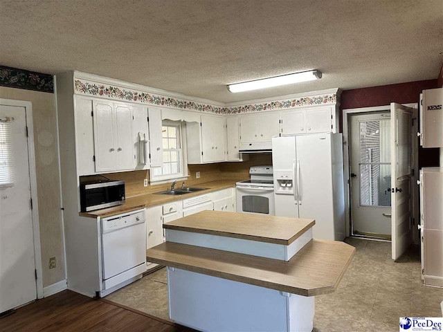 1824 Furman Dr, Florence, SC 29501 - kitchen featuring white appliances, a sink, a kitchen island, white cabinetry, and ventilation hood