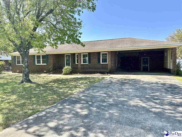 1824 Furman Dr, Florence, SC 29501 - ranch-style home with concrete driveway, a front yard, and brick siding