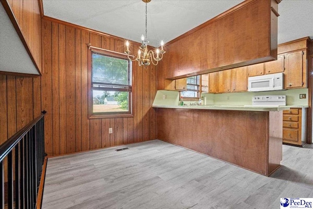 231 Timberlake Dr, Florence, SC 29501 - kitchen featuring white appliances, brown cabinetry, light wood finished floors, light countertops, and a chandelier
