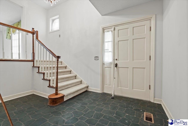 231 Timberlake Dr, Florence, SC 29501 - entryway featuring stone flooring, stairs, and a chandelier