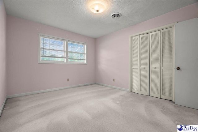 231 Timberlake Dr, Florence, SC 29501 - unfurnished bedroom featuring a textured ceiling, carpet floors, and a closet