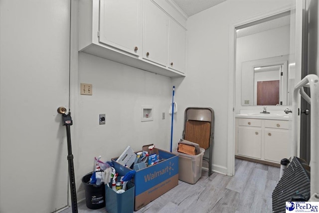 231 Timberlake Dr, Florence, SC 29501 - laundry room featuring cabinet space, hookup for a washing machine, electric dryer hookup, and light wood-style flooring