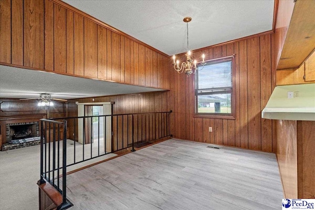 231 Timberlake Dr, Florence, SC 29501 - unfurnished dining area with healthy amount of natural light, ceiling fan, a chandelier, wood walls, and wood finished floors