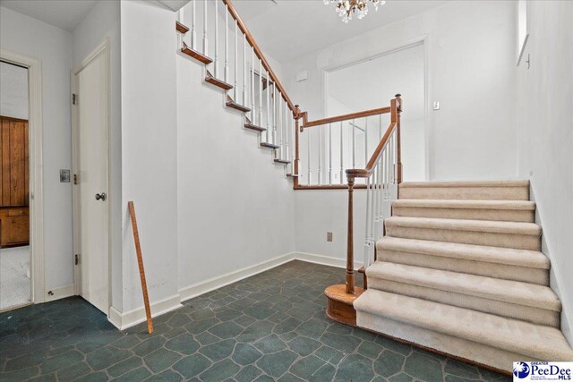 231 Timberlake Dr, Florence, SC 29501 - staircase with a chandelier and baseboards