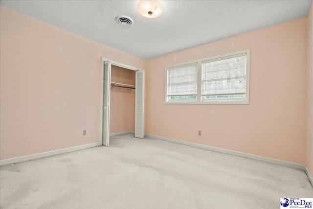 231 Timberlake Dr, Florence, SC 29501 - unfurnished bedroom featuring a textured ceiling, carpet floors, and a closet
