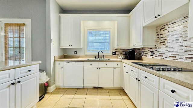 2423 Ben Hogan Cir, Florence, SC 29506 - kitchen featuring dishwasher, a sink, black electric stovetop, light tile patterned floors, and light countertops