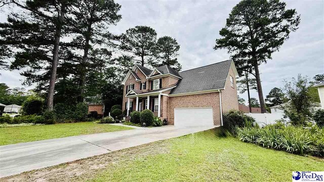 2423 Ben Hogan Cir, Florence, SC 29506 - view of front of home featuring driveway, brick siding, and a garage